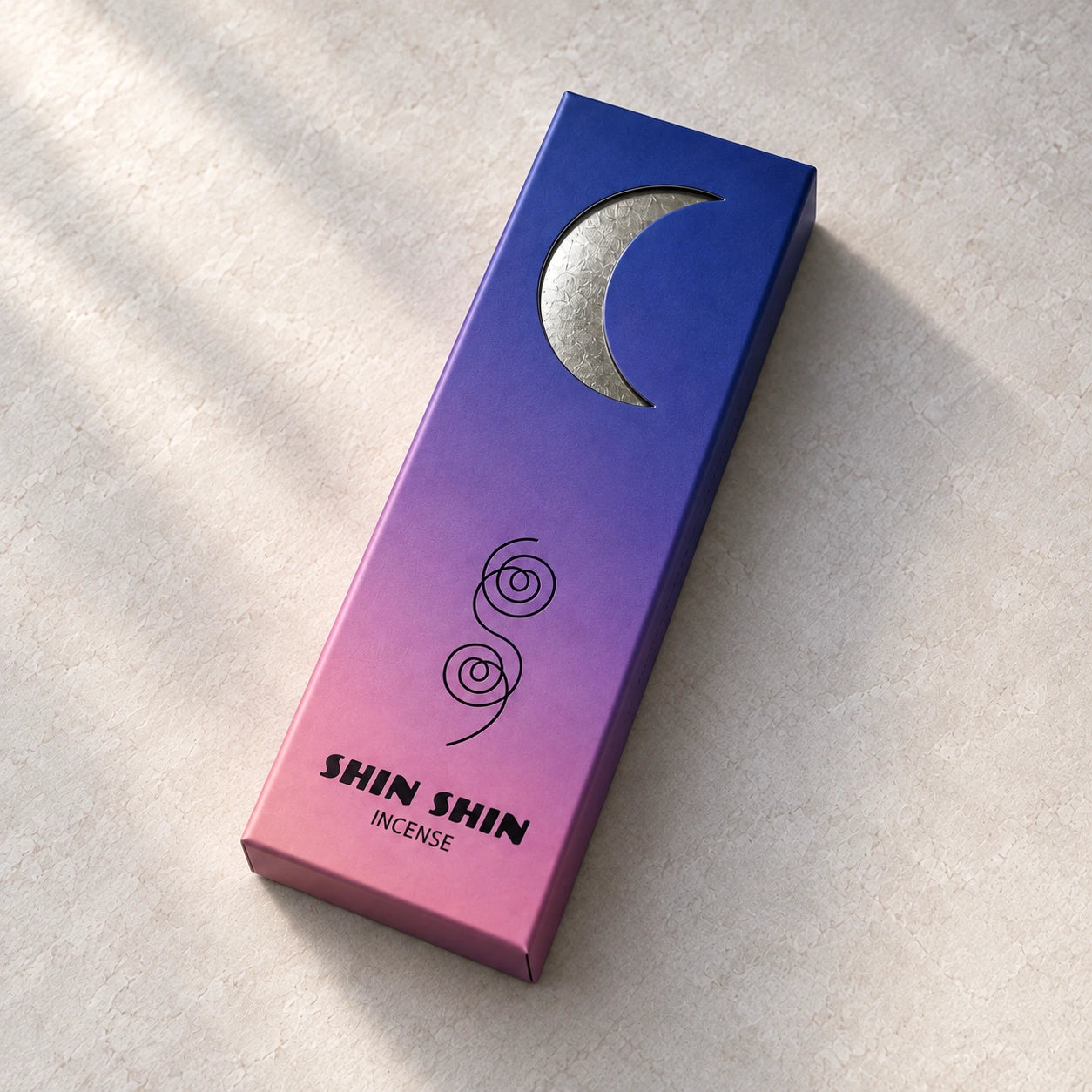 Closed Dusk incense box with a silver crescent on a pale mineral background